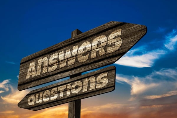 A signpost with Questions and Answers to improve B2B Sales Approach