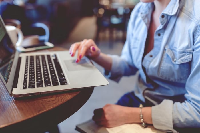 Woman using a laptop to sell charity raffle tickets